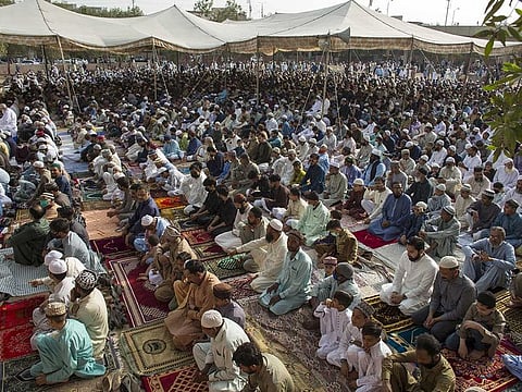 People gather to offer Eid Al Fitr prayers in Karachi, Pakistan, on Thursday, May 13, 2021. 