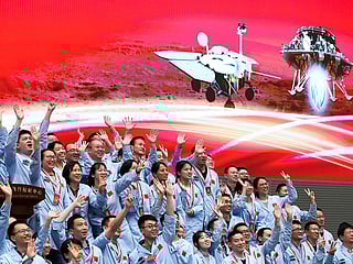 In this photo released by Xinhua News Agency, members at the Beijing Aerospace Control Center celebrate after China's Tianwen-1 probe successfully landed on Mars, at the centre in Beijing. File photo dated Saturday, May 15, 2021. 