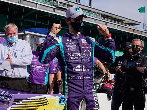 Romain Grosjean celebrates after winning the pole at Indianapolis Motor Speedway