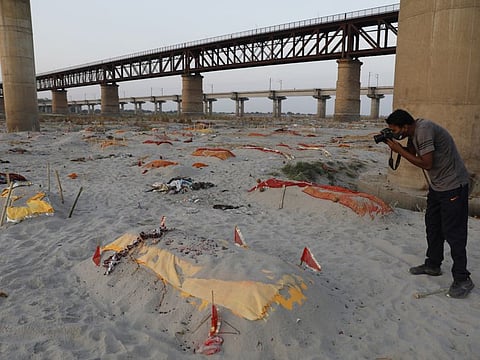 Bodies of suspected coronavirus victims are seen in shallow graves buried in the sand near a cremation ground on the banks of Ganges River in Prayagraj, India. Saturday, May 15, 2021. 