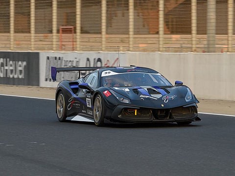 Omar Jackson, Founder of OJ Lifestyle, driving a guest in his Ferrari around the Dubai Autodrome.