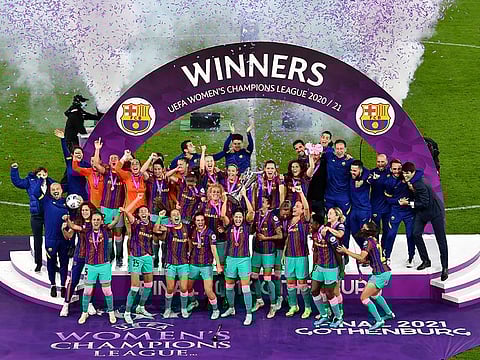 Barcelona players hold the trophy aloft after the UEFA Women's Champions League final.