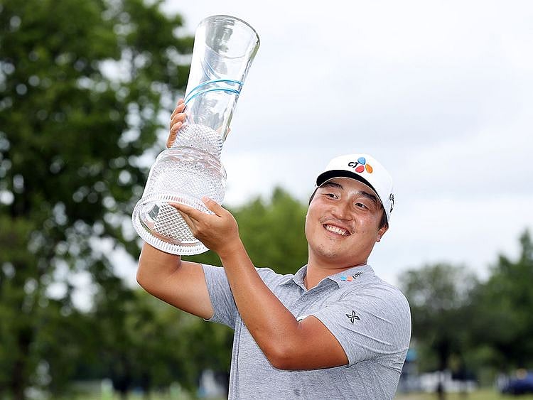 KH Lee of South Korea celebrates with the trophy after winning the AT&T Byron Nelson 