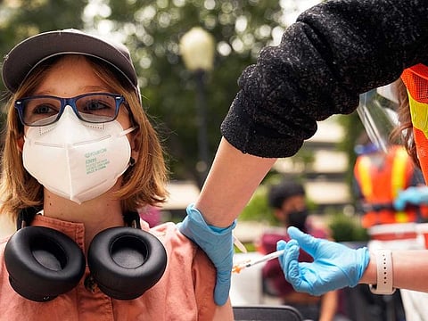 Gigi Morgan Clark, 12, gets a shot of the Pfizer COVID-19 vaccine at the First Baptist Church of Pasadena, Friday, May 14, 2021, in Pasadena, California