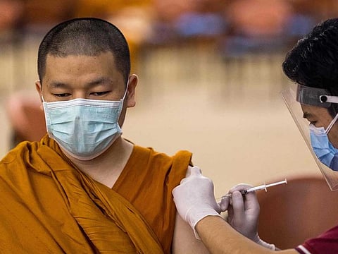 A Buddhist monk is injected with the Sinovac COVID-19 coronavirus vaccine at the Priest Hospital in Bangkok on May 18, 2021. 