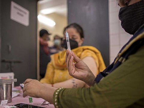 A health worker prepares a dose of COVID-19 vaccine at the heath centre in the village of Bazrak, Uttar Pradesh, India, on Monday, May 17, 2021.