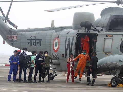 People rescued by the Indian navy from the Arabian Sea arrive in a helicopter at naval air station INS Shikra in Mumbai, in the aftermath of Cyclone Tauktae, Tuesday, May 18, 2021. 