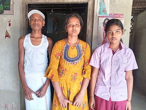 Soni Kumari with her brother and sister. Soni dug a grave in the backyard of her house and buried her mother after relatives and neighbours refused to help.