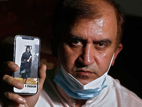 An image of Mayra Zulfiqar, a British woman of Pakistani origin who was found dead at a home, is displayed by her father Muhammad Zulfiqar on his mobile phone during an interview  in Lahore, Pakistan, Thursday, May 20, 2021.