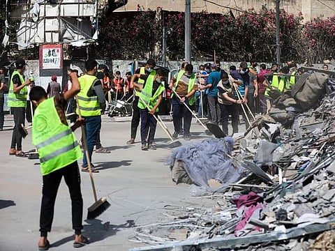 Volunteers clean up the streets in Gaza.