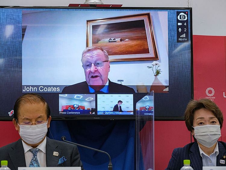 CEO of the Tokyo 2020 Toshiro Muto, left, and President of the Tokyo 2020 Seiko Hashimoto, right, listen to IOC Vice President  John Coates, (on screen), delivering a speech during the Tokyo 2020 IOC Coordination Commission press conference in Tokyo. 