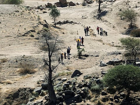 Ethiopians fleeing from the Tigray region walk towards a river to cross from Ethiopia to Sudan, near the Hamdeyat refugee transit camp, which houses refugees fleeing the fighting in the Tigray region, on the border in Sudan, December 1, 2020. 