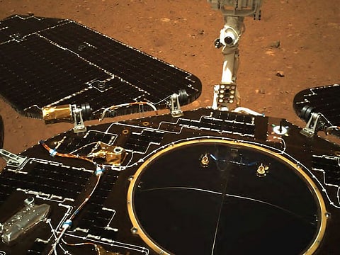 This picture released on May 19, 2021, by the China National Space Administration (CNSA) via CNS shows an image taken by the navigation camera of China's Zhurong rover on the surface of Mars, showing the rover's solar panels and antenna, after it landed on Mars on May 15, 2021. 