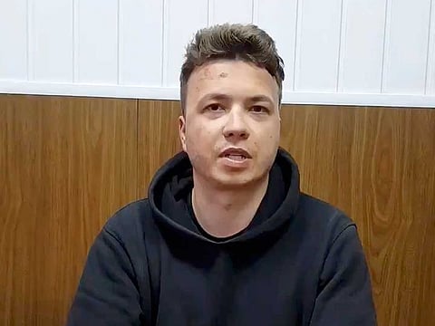 In this handout photo released Monday, May 24, 2021, by Belarus Government press office, Belarus journalist Raman Pratasevich speaks to a camera in a prison in Minsk, Belarus.  The brief video clip of Pratasevich in custody was shown on Belarusian state television Monday night. He sat at a table with his hands folded in front of him and spoke rapidly, saying he was in satisfactory health, and that his treatment was "maximally correct and according to law." He added that he was giving evidence to investigators about organizing mass disturbances.