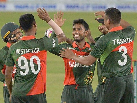 Bangladesh's Mehedi Hasan Miraz (C) celebrates with teammates after the dismissal of the Sri Lanka's  Wanindu Hasaranga. 
