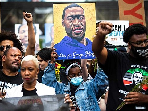 People raise their fists as they march during an event in remembrance of George Floyd in Minneapolis, Minnesota, on May 23, 2021. 