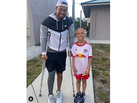 Tiger Woods with young fan Luna Perrone