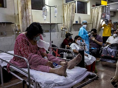 A patient suffering from the coronavirus disease (COVID-19) receives treatment inside the casualty ward at a hospital in New Delhi. 