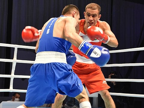 India's Amit Panghal, defending champion in men's 52 kg (right), in action during the final against reigning Olympics champion Zoirov Shakhobidin in Dubai.