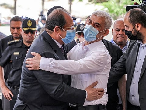 Yahya Sinwar (left), Hamas' political chief in Gaza, embraces General Abbas Kamel (right), Egypt's intelligence chief, as the latter arrives for a meeting with leaders of Hamas in Gaza City on May 31, 2021. 