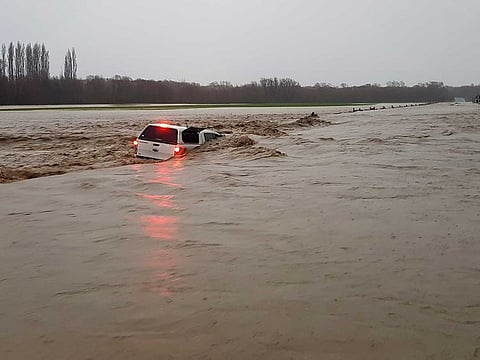 In this photo released by Chris Allen, a car is abandoned in flooded waters in Ashburton Forks near Christchurch, New Zealand, Sunday May 30, 2021. Several hundred people in New Zealand were evacuated from their homes while others recounted dramatic helicopter rescues as heavy rain caused widespread flooding in the Canterbury region. 