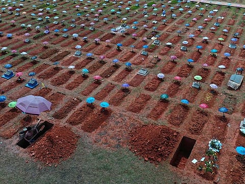In this March 20, 2021 file photo, a worker digs a grave in the San Juan Bautista cemetery in Iquitos, Peru, amid the new coronavirus pandemic. On May 31, 2021, Peru announced a sharp increase in its COVID-19 death toll, saying there have been more than 180,000 fatalities since the pandemic hit the country early last year.
