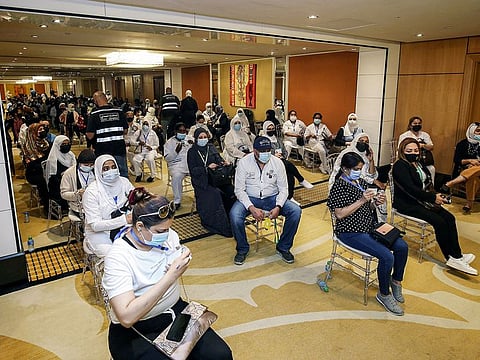 A health worker administers a dose of the Pfizer-BioNTech COVID-19 vaccine in Kuwait City. 
