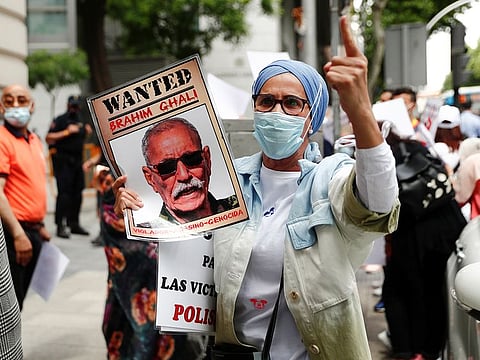 A demonstrator holds a placard during a protest against Brahim Ghali, president of the Sahrawi Arab Democratic Republic (SADR) and Secretary General of the Polisario Front (Popular Front for the Liberation of Saguia el-Hamra and Rio de Oro), outside Spanish High Court in Madrid, Spain, June 1, 2021. 