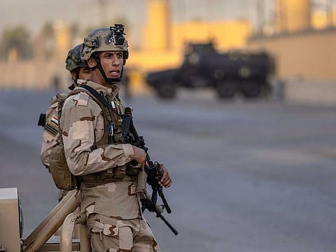 Iraqi Army soldiers stand guard on a road between the US Embassy and the International Zone on May 30, 2021 in Baghdad, Iraq. 