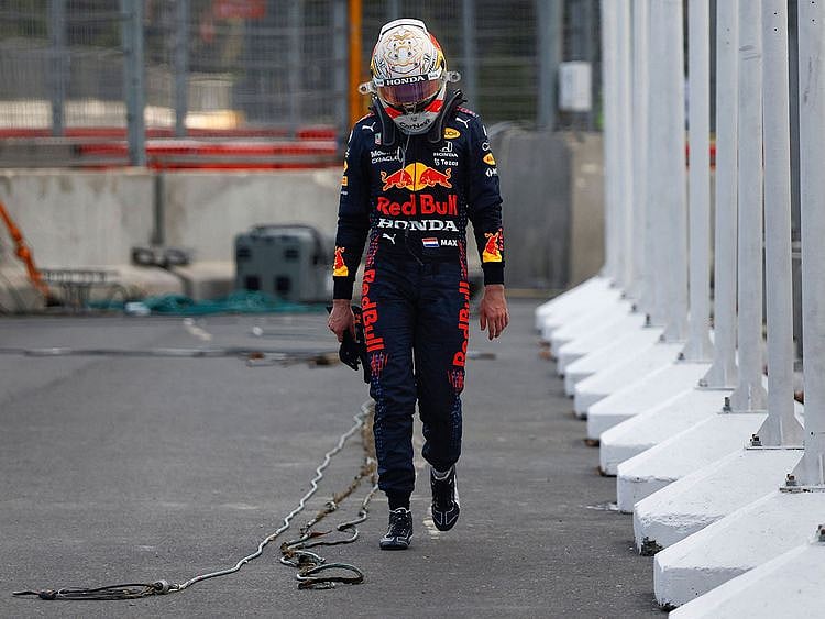 Red Bull's Dutch driver Max Verstappen walks to the pits after a crash during the Formula One Azerbaijan Grand Prix 