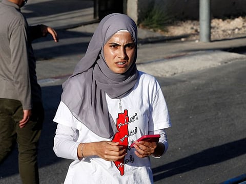 Palestinian activist Mona Al Kurd takes part in a rally to demand the reopening of the Israeli Police checkpoint at the entrance to the Sheikh Jarrah neighbourhood in east Jerusalem. 