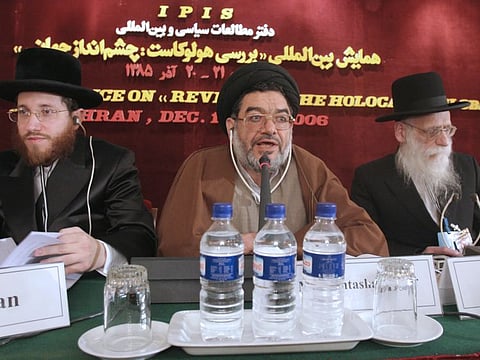 In this December 11, 2006, photo, Mohtashamipour speaks, as Rabbi Moishe Arye Friedman, left, from Austria, and Rabbi Ahron Cohen from England, at a conference on the Holocaust, in Tehran.