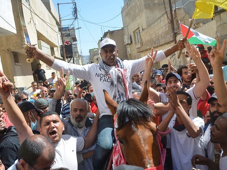 Abdullah Abu Jaber, longest serving Jordanian prisoner in Israeli jails, is welcomed after being released, as he arrives at Baqaa refugee camp, near Amman, Jordan, June 8, 2021. REUTERS/Muath Freij