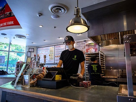 Togi, an 11th grade student at Wakefield High School, is seen at work in a fast food restaurant in Arlington, Virginia, on June 6, 2021.