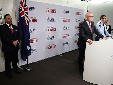 Australia's Prime Minister Scott Morrison speaks as Anthony Russo (left), the Federal Bureau of Investigation's legal attaché to the US embassy in Sydney, and Australian Federal Police Commissioner Reece Kershaw look on during a press conference in Sydney on June 8.