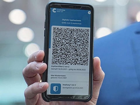 Jens Spahn, Federal Minister of Health, shows the app for the digital vaccination certificate at the regular press conference on the Corona situation in Berlin.  