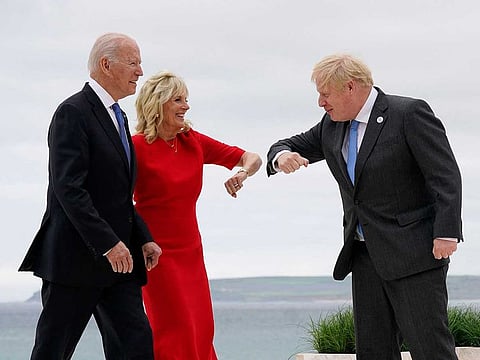 US President Joe Biden (L) watches as US First Lady Jill Biden (C) elbow bumps with Britain's Prime Minister Boris Johnson during the G7 summit in Carbis Bay, Cornwall, south-west England on June 11, 2021.