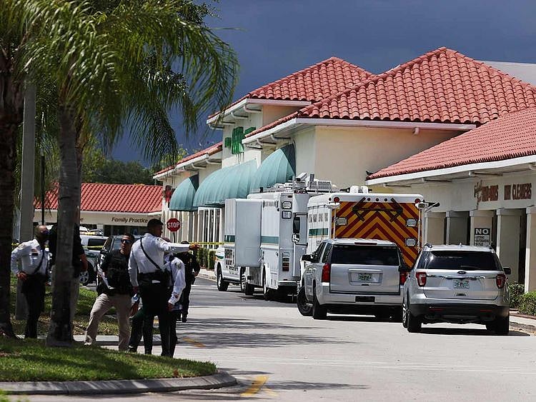 Palm Beach County Sheriff’s officers stand outside of a Publix supermarket