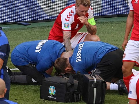  Denmark's defender Simon Kjaer (back) observes as paramedics attend to Denmark's midfielder Christian Eriksen (not seen) during the UEFA EURO 2020 Group B football match between Denmark and Finland at the Parken Stadium in Copenhagen on June 12, 2021. 