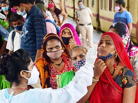 A medic collects nasal sample from a passenger at Dadar station in Mumbai. 