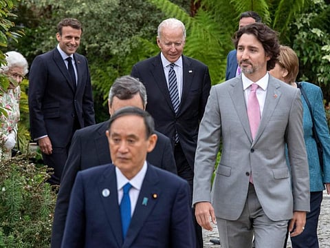 US President Joe Biden (centre) and G7 leaders arrive for a family photograph during a reception at The Eden Project in south west England on June 11, 2021. 