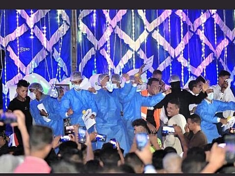 Guests wearing medical attire look happy at the wedding