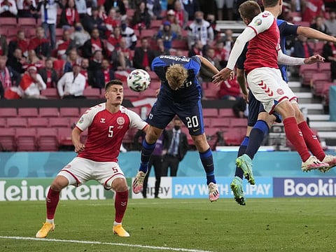 Finland's Joel Pohjanpalo, centre, scores his side's opening goal during the Euro 2020 soccer championship group B match between Denmark and Finland at Parken stadium in Copenhagen, Saturday, June 12, 2021.