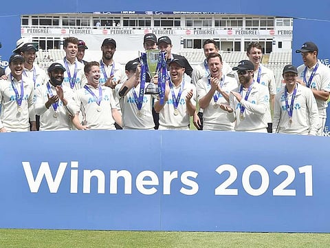 New Zealand players celebrate with the winners trophy after their win in the second Test against England at Edgbaston in Birmingham, on June 13, 2021.  