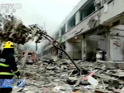 In this image taken from a video footage run by China's CCTV, a firefighter walks near the aftermath of a gas explosion in Shiyan city in central China's Hubei Province on Sunday, June 13, 2021. 