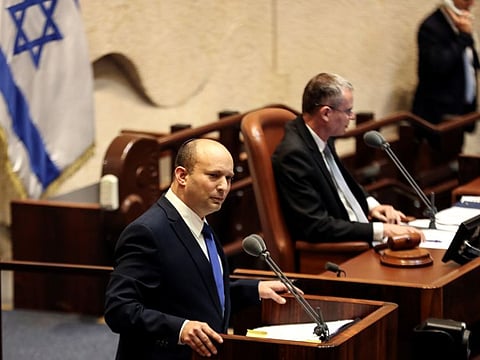 Naftali Bennett, Prime Minister-designate, speaks at the Knesset during a special session where a confidence vote will be held to approve and swear-in a new coalition government, in Jerusalem on June 13.