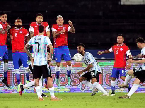 Argentina's Lionel Messi curves in a freekick around the Chile wall to score their only goal in Copa America in Brazil on Monday.