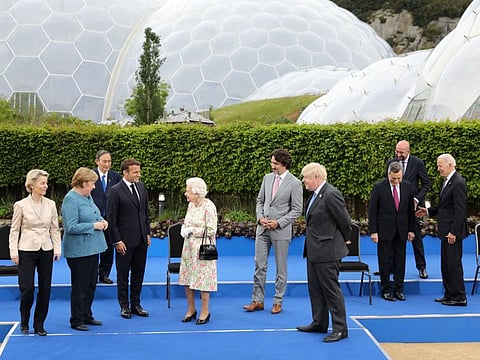 Queen Elizabeth II reacts after posing for a photograph with G7 leaders from Canada, France, Germany, Italy, Japan, the UK and the United States at Carbis Bay, Cornwall, UK