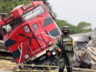 Photos: One dead as freight train topples onto Mexican homes