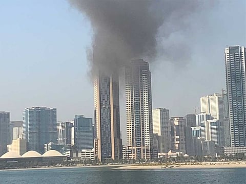 Smoke and flames can be seen on the top floor of the multi-storey building